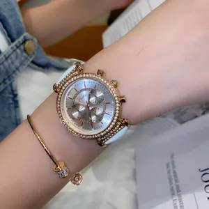 Detail view of Scottie 9136 watch with rhinestone bezel and white leather strap