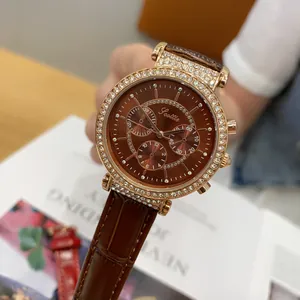 Close-up detail of Scottie 9136 watch with brown leather strap and rhinestone bezel