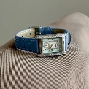 Close-up of Scottie vintage rectangular watch with rhinestone bezel and macaron dial
