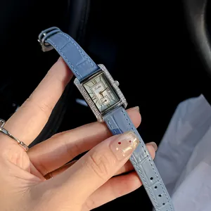 Close-up of Scottie vintage rectangular watch with blue leather strap and diamond bezel
