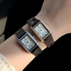 Detailed view of two Scottie vintage rectangular watches with diamond bezels on a wrist