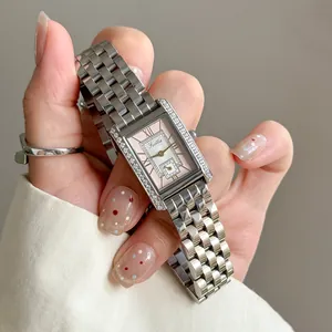 Close-up of Scottie 9655 silver watch with pink dial and rhinestone details on hand.