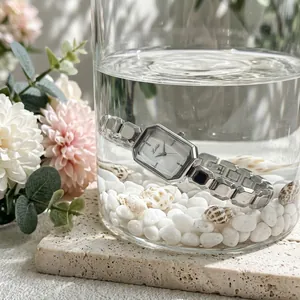Close-up of a premium silver-toned women's waterproof quartz watch submerged in clear water