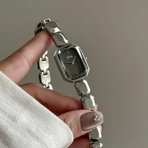 Detailed view of a Scottie silver luxury watch with a faceted rectangular dial.