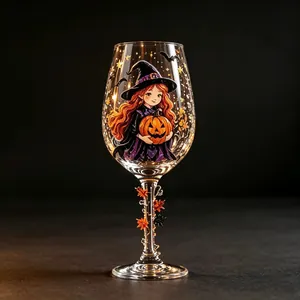 Intricate Halloween wine glass detail featuring a cute witch holding a pumpkin