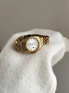Close-up of Scottie luxury gold women's watch with fluted bezel and crystal markers