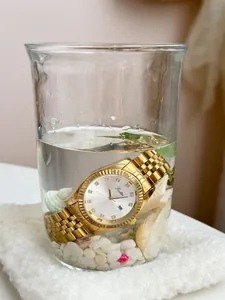 Close-up of Scottie 9570 luxury gold women's watch submerged in water to show waterproof feature.