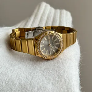Close-up of gold Scottie women's watch featuring a luxury crystal-encrusted bezel