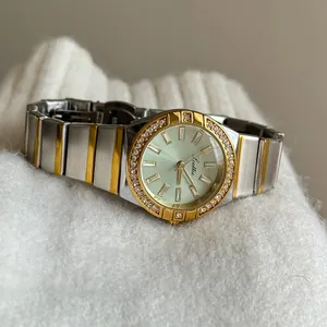 Elegant two-tone Scottie ladies' quartz watch with crystal bezel on a soft white sweater