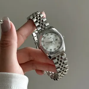 Close-up of a luxury silver ladies' quartz watch featuring crystal hour markers and date window