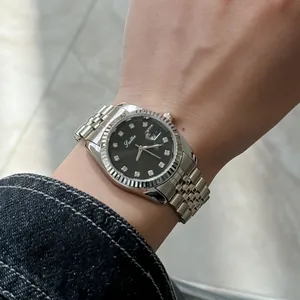 Detailed shot of Scottie luxury silver quartz watch with black dial and diamond markers.