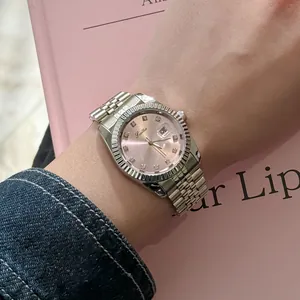 Macro detail of Scottie luxury quartz watch with pink dial and silver metal band