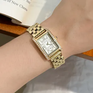 Elegant Scottie 9655 gold rectangular watch with diamond bezel on wrist.
