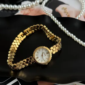 Macro view of gold honeycomb bracelet and mother-of-pearl dial on Scottie ladies quartz watch