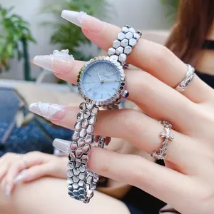 Close-up detail of Scottie 9615B silver honeycomb band watch with blue pearl dial