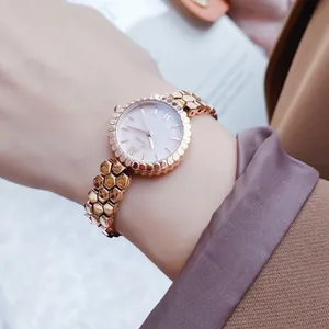 Close-up of Scottie women's quartz watch with rose gold honeycomb band and pearl dial.