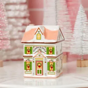 Festive Christmas Village Spice House ceramic jar with pink roof and holiday decor.