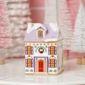 Festive ceramic poultry seasoning jar shaped like a snowy purple roof village house.