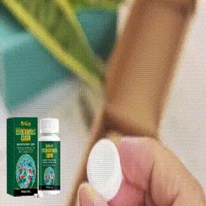 Detailed view of a white water purifying tablet being held against an aquarium background