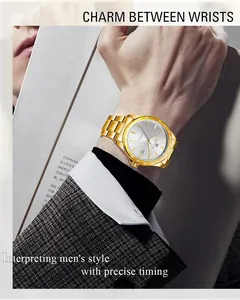 Men's minimalist gold-toned automatic mechanical watch with steel strap on wrist