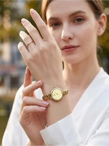 Close-up of GEDI gold-tone women's watch with hollow chain strap on model's wrist