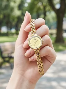 Elegant GEDI gold-tone women's quartz watch with a refined chain bracelet held in hand