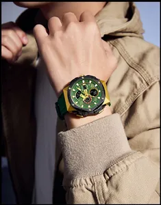 Close-up of SMAEL green sports watch with gold-tone alloy case on male model's wrist