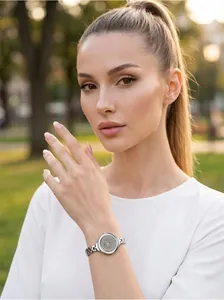 Elegant women's quartz watch with silver bracelet worn by model in outdoor light