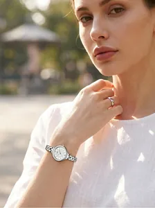 Detail of GEDI minimalist women's quartz watch with silver hollow link bracelet on wrist.