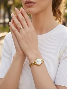 Detailed shot of GEDI minimalist gold chain watch paired with elegant white ribbed top