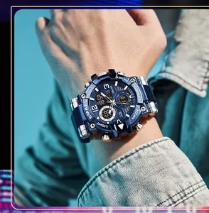 Close-up of SMAEL blue men's sports watch on wrist with denim jacket details.