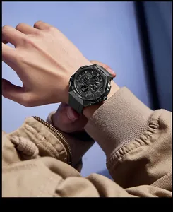 Close-up view of a rugged black SMAEL men's sports watch worn on a wrist with a khaki jacket
