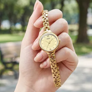 Elegant GEDI gold chain strap women's quartz watch shown in a natural outdoor setting