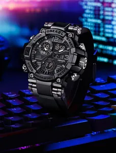 Close-up detail of SMAEL black dual-display sports watch resting on a neon gaming keyboard