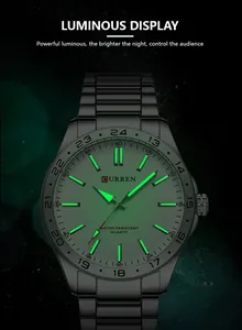 Close-up of CURREN men's business steel watch featuring green luminous display at night