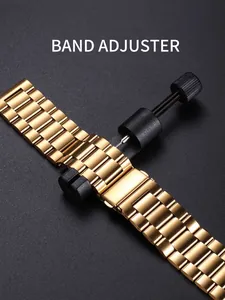 Detail eines goldfarbenen Uhrenarmbands mit Gliederentferner zur Größenanpassung