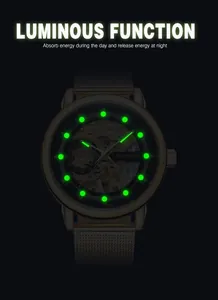 Macro view showing the bright green luminous markers on a skeleton mechanical watch dial