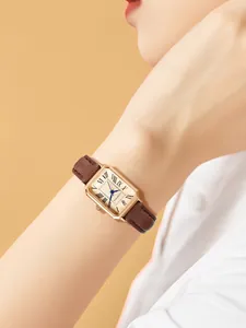 A close-up view of the vintage rectangular quartz watch by LUCKY FOX on a female wrist.