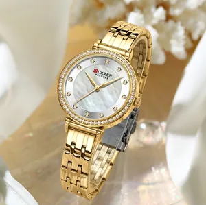 Vista detallada del reloj CURREN dorado para mujer con bisel de strass y esfera de perla