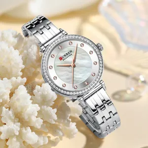Primer plano detallado del reloj CURREN 9087 para mujer con esfera de nácar y pedrería