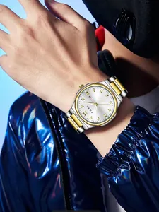 A detailed view of the Tomi men's luxury silver and gold quartz watch on wrist