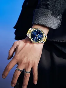 Close-up of TOMI men's quartz watch with blue dial and bicolor steel strap
