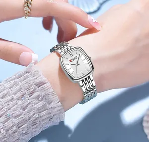 Detailed view of CURREN 9093 square women's minimalist silver watch worn on a wrist