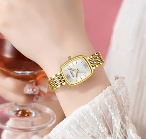 Detailed lifestyle view of a golden Curren square quartz watch on a woman's wrist