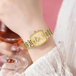 Detail shot of CURREN 9093 gold square watch for women on wrist with lace sleeve