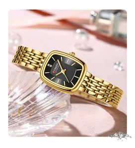 Elegant gold CURREN 9093 women's square watch with black dial on a glass tray