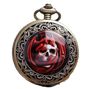 Vintage bronze pocket watch featuring a red dragon and skull design on white background.