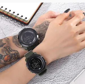 Close-up of green TOMI digital sports watches worn on arms showing functional buttons