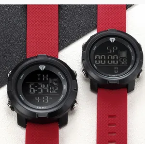 Detailed close-up showing the digital display and red textured strap of TOMI sports watch.