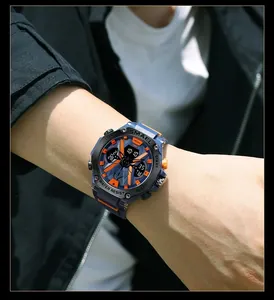 Detailed view of SMAEL dual display sports watch with blue and orange accents on wrist